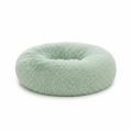 Sage green round donut pet bed with long shaggy faux fur and a deep cushioned center, shown on a white background