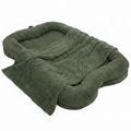 Oversized olive green plush human-sized dog bed with bone-shaped bolster sides and matching faux fur blanket on white background