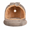 Grey suede plush dome cat bed with matching grey bow on top, hanging white pom pom ball, caramel tan fluffy interior lining, on a clean white background