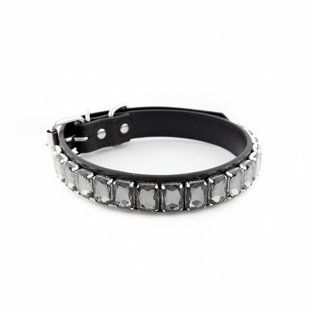 Grey rhinestone dog collar displayed against a soft lavender studio background.