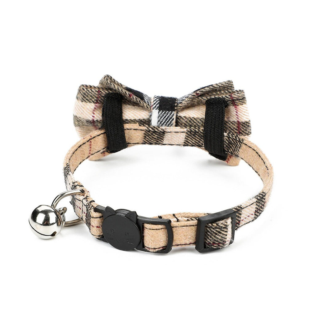 Plaid dog collar with bow tie and bell on a white background