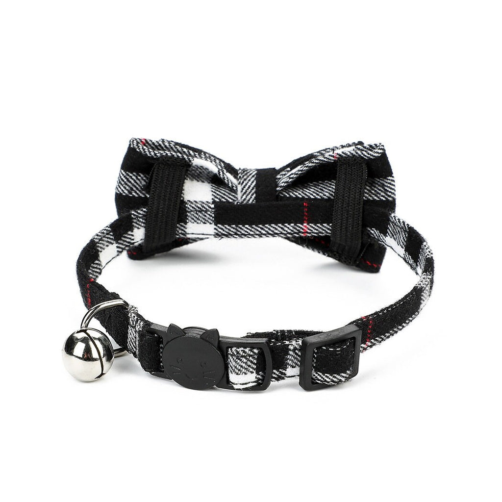 Black and white tartan plaid cat collar with bow tie, silver bell, and cat-shaped safety breakaway buckle with red accent stripe