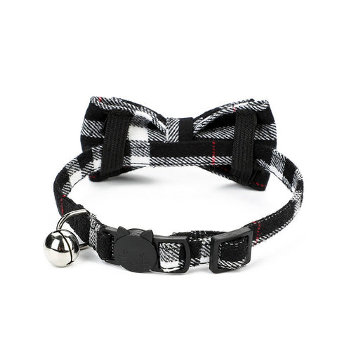 Black and white tartan plaid cat collar with bow tie, silver bell, and cat-shaped safety breakaway buckle with red accent stripe
