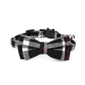 Black and white plaid bow tie cat collar with a bell on a white background