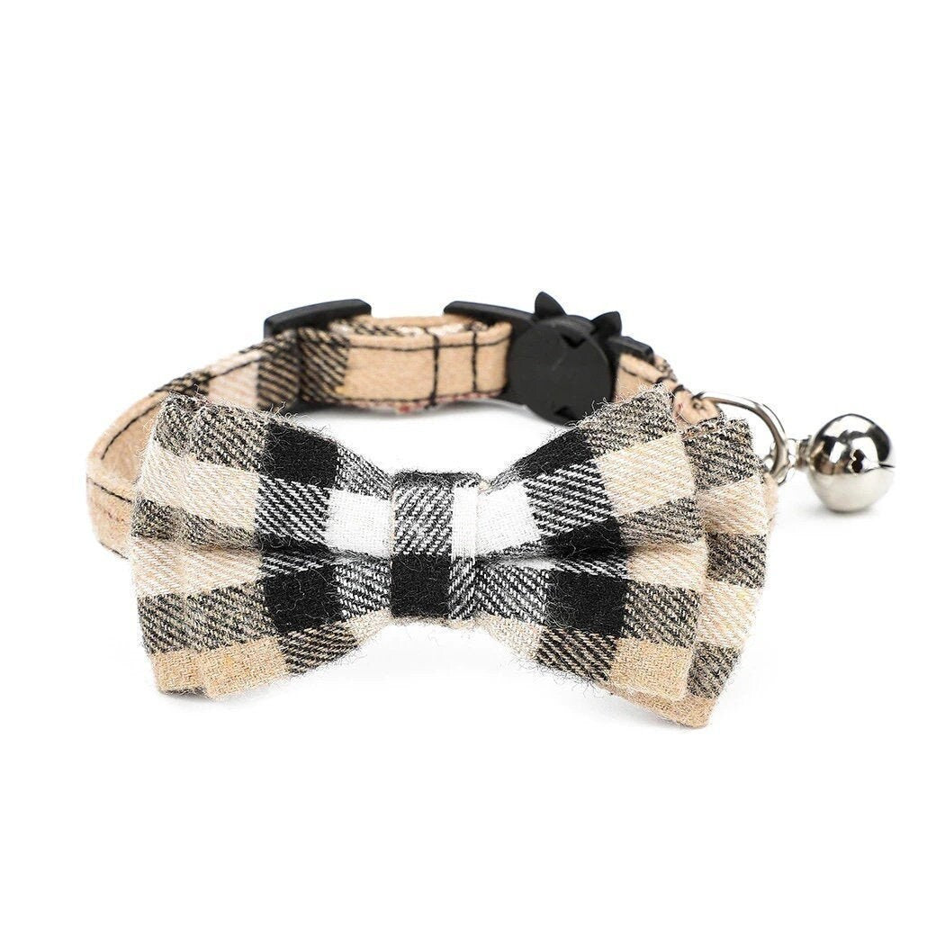 Beige and black buffalo plaid cat collar with bow tie, silver bell, and cat-shaped safety breakaway buckle