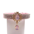 Pink velvet luxury dog collar with triple-row crystal rhinestone band, gold baroque filigree rose quartz centerpiece, and dangling pink teardrop gem