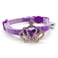 Purple velvet pet collar with gold crown amethyst teardrop crystal centerpiece, rhinestone halo setting, and silver bell on white background for cats and dogs