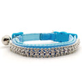 Blue cat collar with a decorative crystal trim with bell on a white background