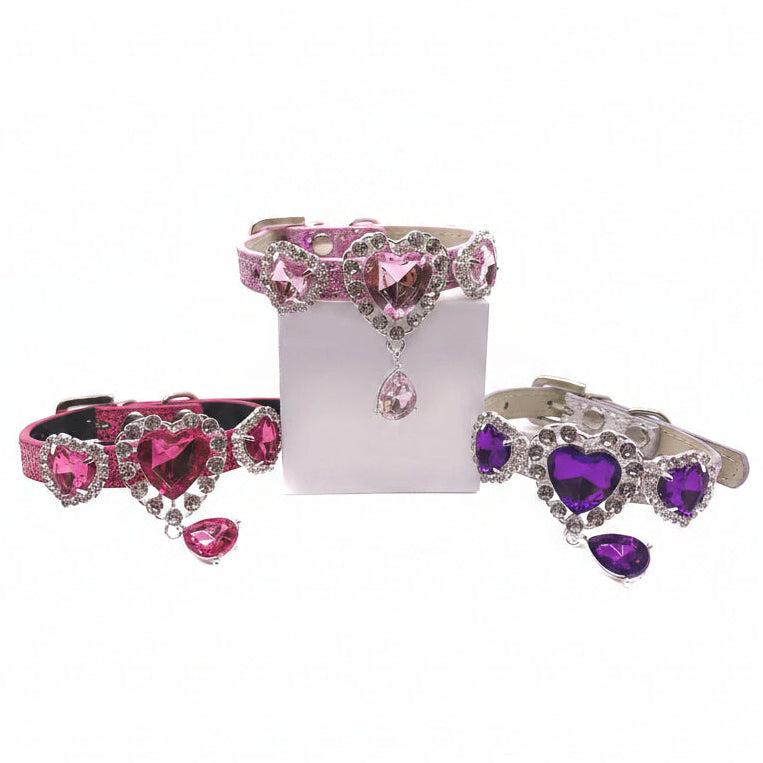 Luxury rhinestone heart pet collar collection in pink, hot pink, and purple glitter with crystal halo settings and teardrop pendant charms for cats and dogs