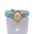 Light blue glitter luxury pet collar with gold oval moonstone centerpiece, crystal halo, and dangling pearl teardrop charm, silver buckle clasp