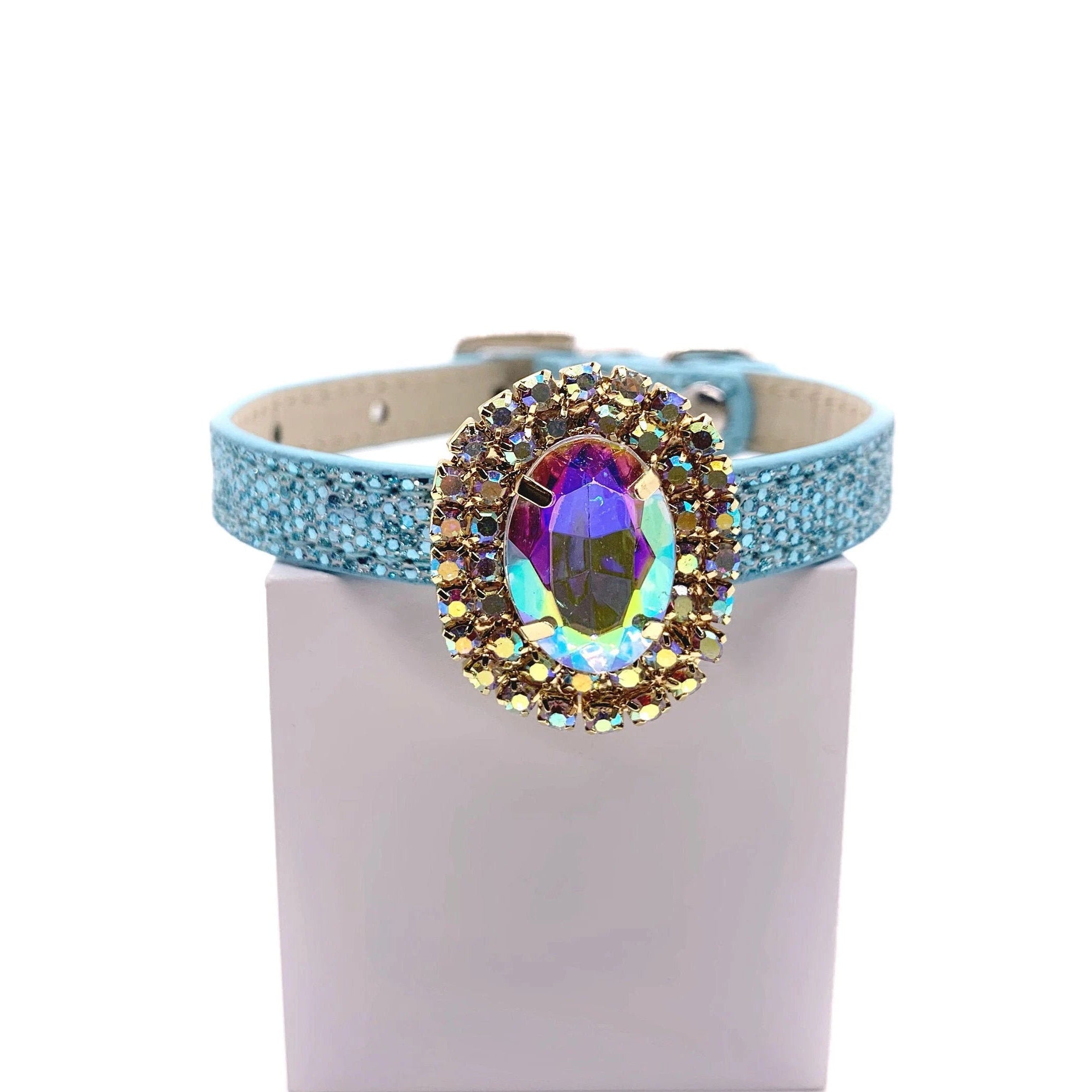 Baby blue glitter pet collar with aurora borealis iridescent oval crystal centerpiece and double halo of gold AB rhinestone accent stones for cats and dogs