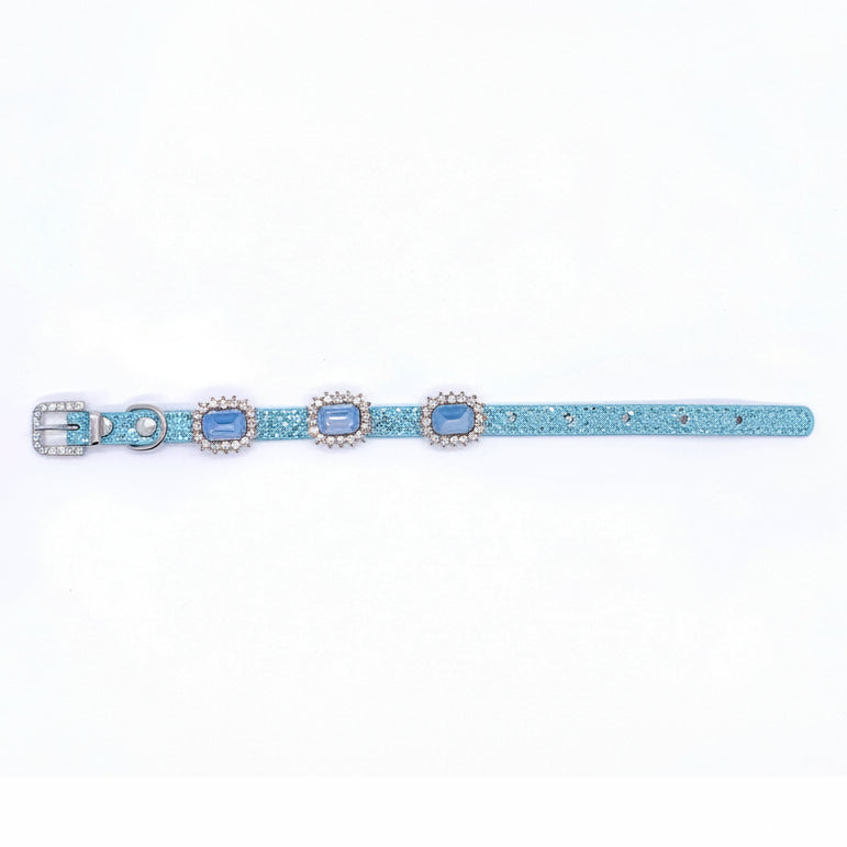 Baby blue glitter pet collar with three light blue emerald-cut crystal cabochon charms in rhinestone halo settings laid flat showing full length with rhinestone-encrusted buckle for cats and dogs