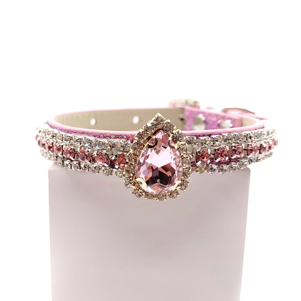 Pink pet collar with double-row crystal rhinestone band, rose pink teardrop centerpiece brooch in gold rhinestone halo setting displayed on stand for cats and dogs
