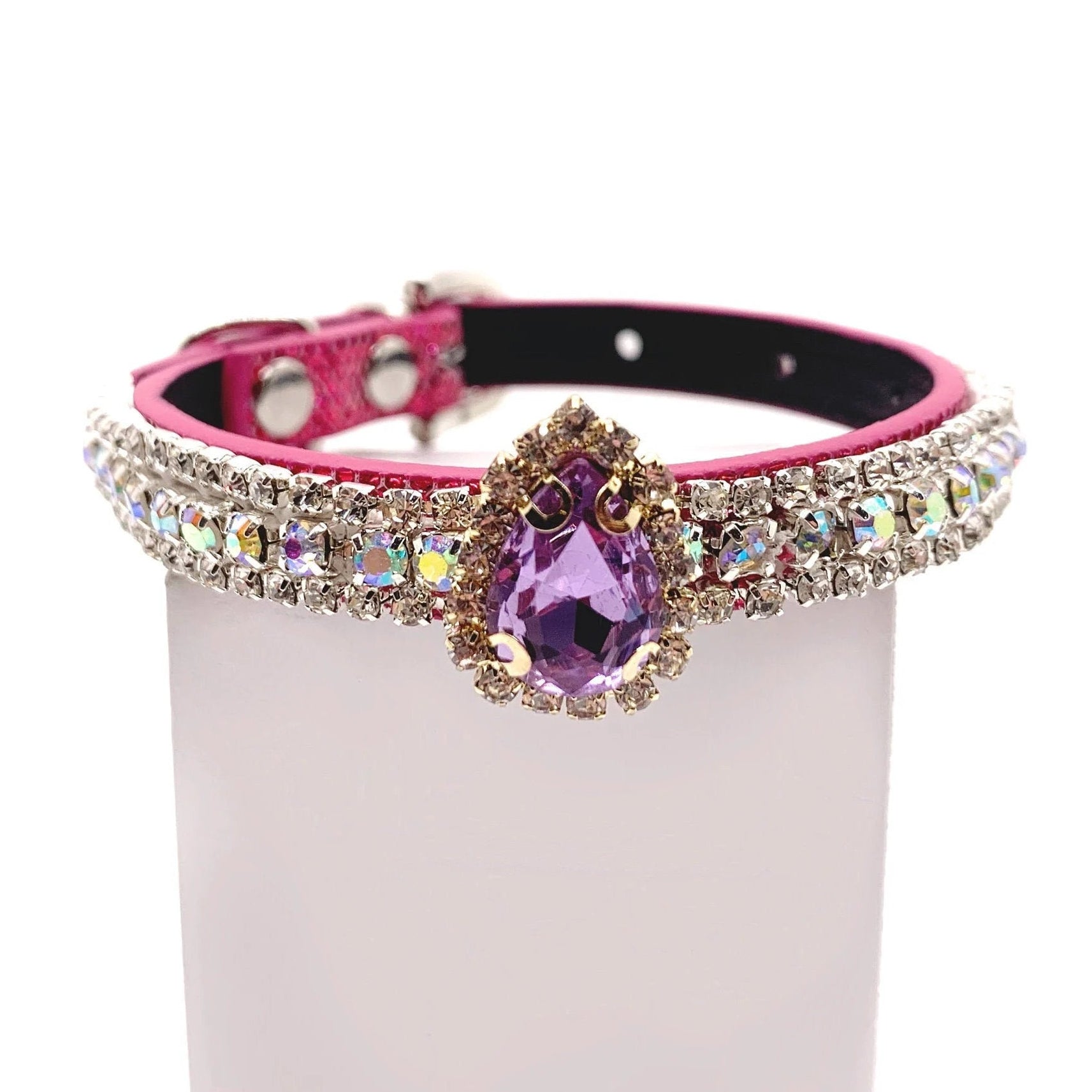 Pink dog collar with aurora borealis crystal rhinestone band and amethyst purple teardrop centerpiece charm for cats and dogs on a white background