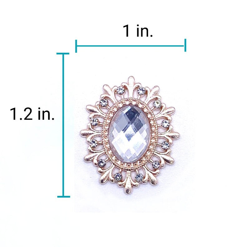 Size diagram of 1 inch wide by 1.2 inch tall gold ornate sunburst brooch with clear faceted oval crystal centerpiece and rhinestone accent halo for luxury pet collar