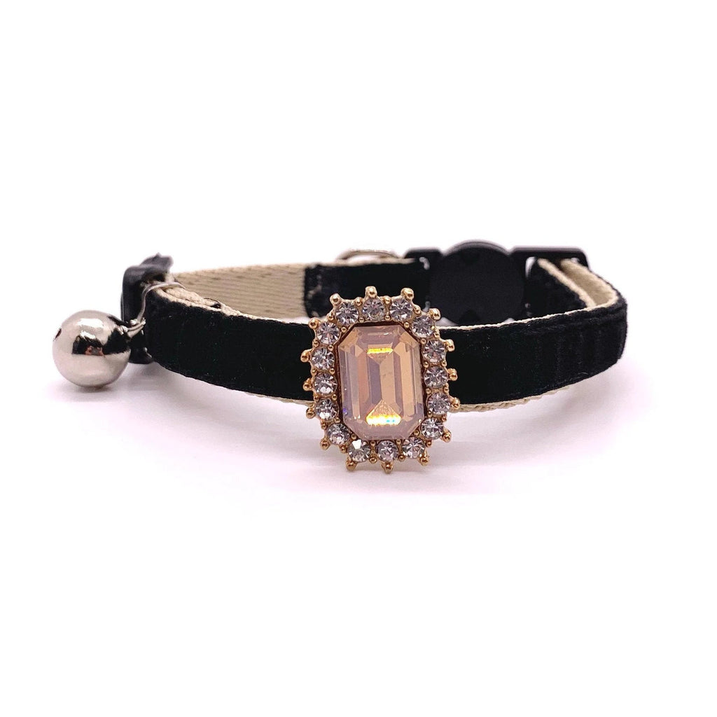 Black velvet pet collar with iridescent opal champagne emerald-cut rhinestone charm, gold halo setting, and silver bell