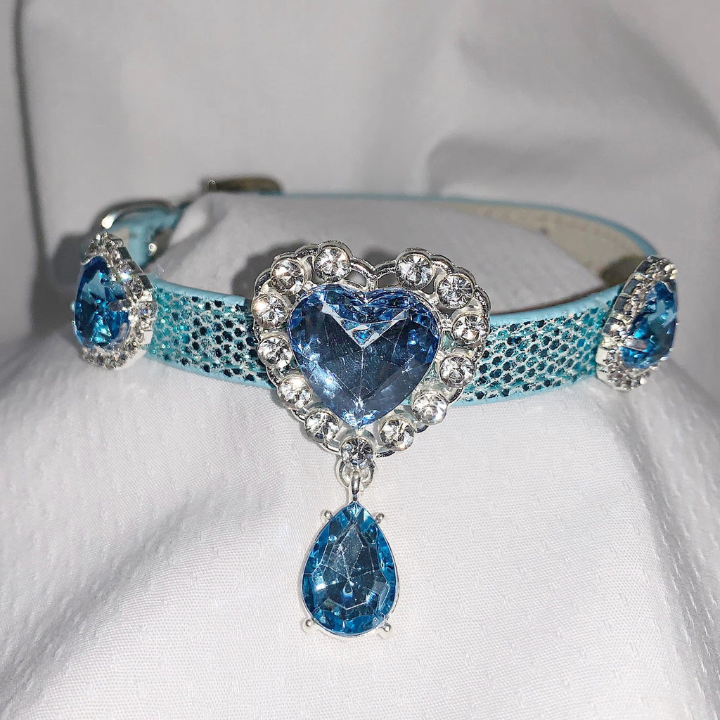 Luxury aqua blue glitter pet collar with sapphire heart rhinestone centerpiece, crystal halo setting, teardrop pendant charm, and side gemstone accents for cats and dogs