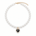 Faux pearl pet necklace collar with black heart pendant on white