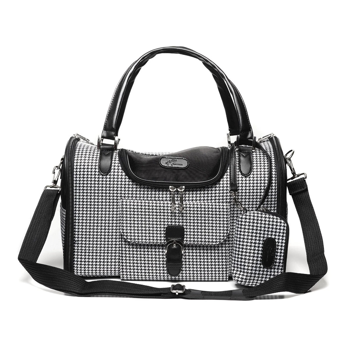 A black and white houndstooth pattern  pet carrier with black leather trim, dual top handles, a front flap pocket, and an adjustable shoulder strap, shown on a plain white background.