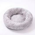 Light gray plush donut pet bed on a white background