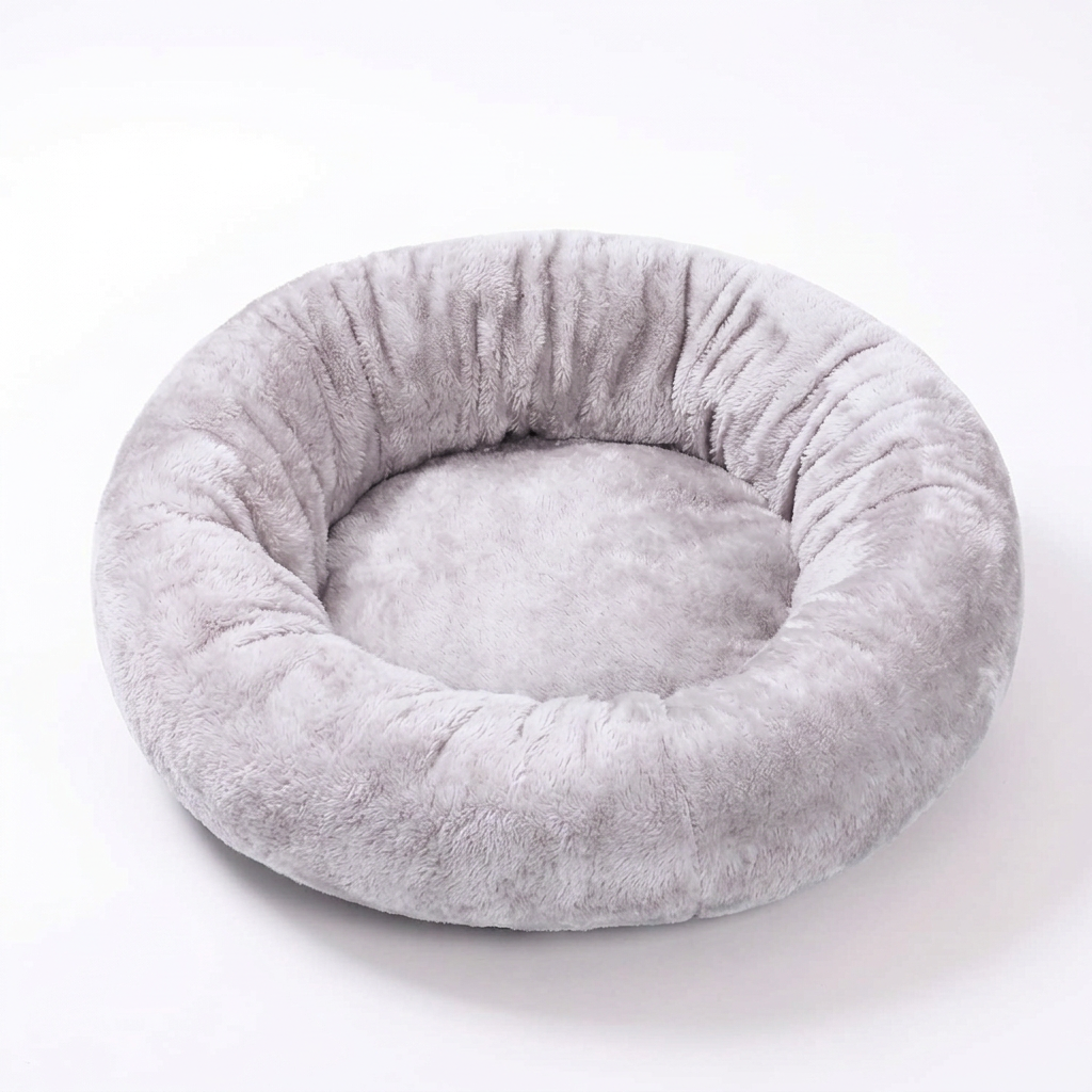 Light gray plush donut pet bed on a white background