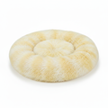 Round light yellow tie-dye shaggy faux fur donut calming pet bed top-down view on white background