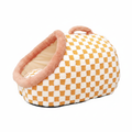 Mustard yellow and white checkerboard plush pet igloo cave bed with blush pink padded dome entrance and handbag-style carry handle on white background