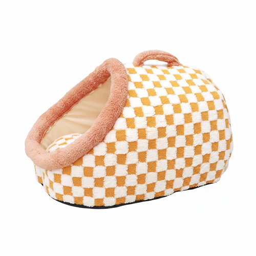 Mustard yellow and white checkerboard plush pet igloo cave bed with blush pink padded dome entrance and handbag-style carry handle on white background