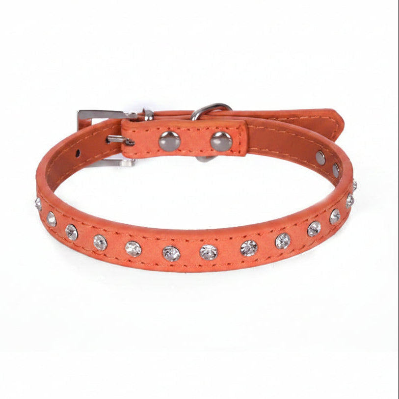 Orange leather cat and dog collar with single row clear rhinestone crystals and silver buckle, angled side view luxury bling pet collar product photo on white background