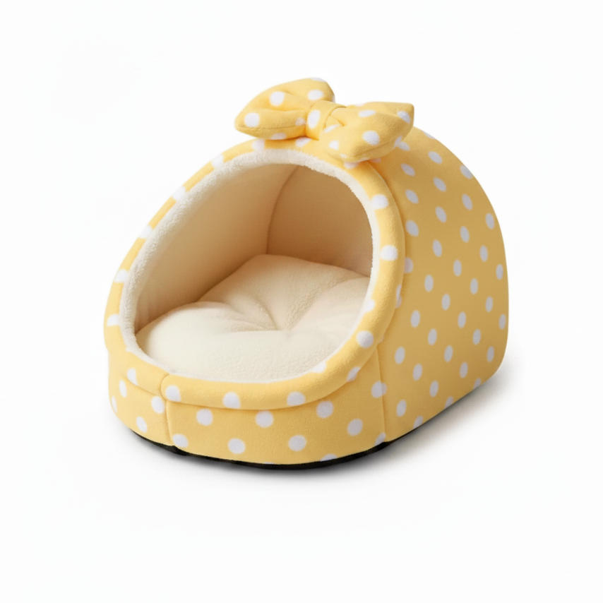 Pale yellow white polka dot igloo cat cave bed with matching bow detail and cream fleece interior, white background