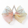 Pastel rainbow crown bow resting on a white surface to match the other product images