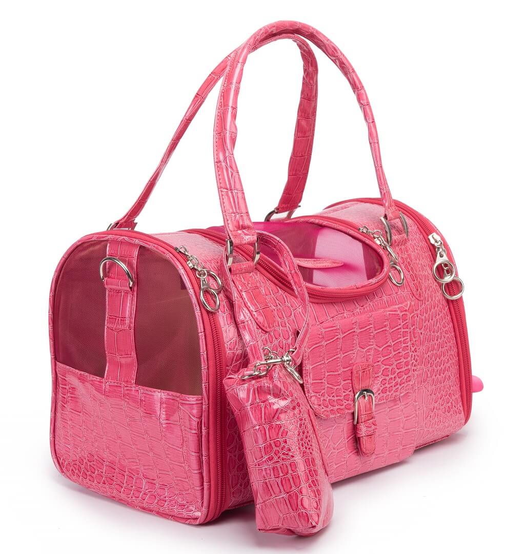 A bright pink crocodile-embossed pet carrier bag with matching zippered pouch and handles, shown on a clean white background.