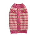 Pink and cream sweater with gold buttons on a square white background