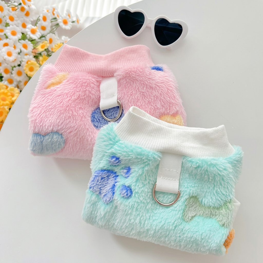 Pink and mint sweaters on the table with the paper removed
