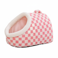 Pink and white checkerboard plush pet igloo cave bed with padded dome entrance and bear ear accents on white background
