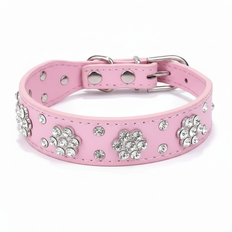Pink jeweled pet collar with a bright pink interior, displayed against a soft lavender studio background.