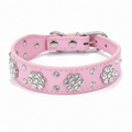 Pink jeweled pet collar with a bright pink interior, displayed against a soft lavender studio background.