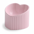 Pink ceramic heart-shaped pet bowl with ribbed exterior, white background
