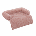 Dusty blush pink long shaggy faux fur sofa cover protector with raised bolster back and sides and a flat front drape panel, shown at a 3/4 angle on a white background