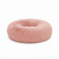 Blush pink round donut pet bed with long shaggy faux fur and a deep cushioned center, shown on a white background