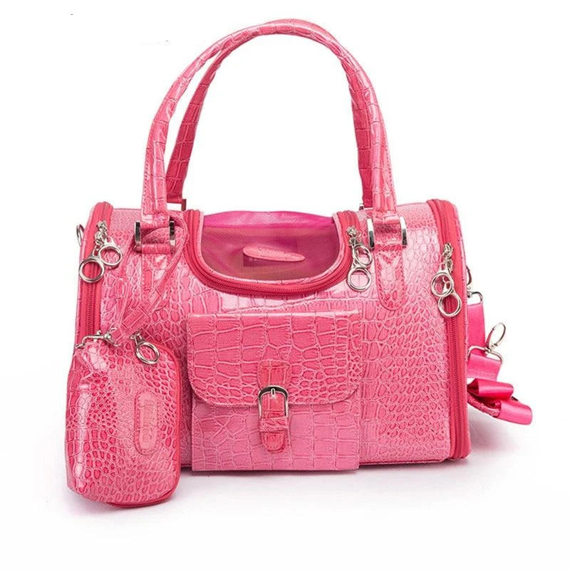 Pink pet carrier with clear pouch on a white background