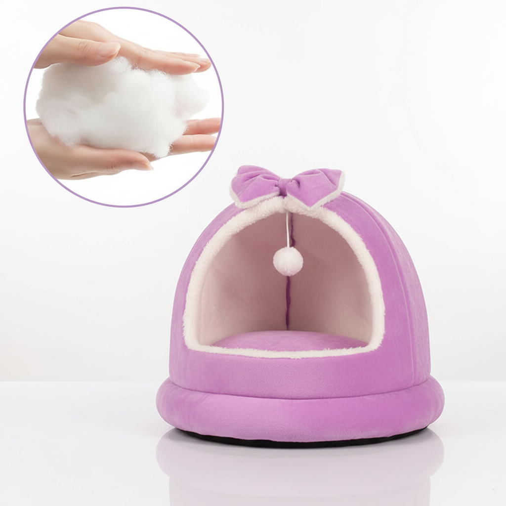 Purple plush dome cat bed with matching bow on top, cream interior lining, and circular inset detail showing ultra-soft cotton filling, on a clean white background