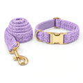 Purple teddy fleece collar and leash set arranged with the leash on the left and collar on the right