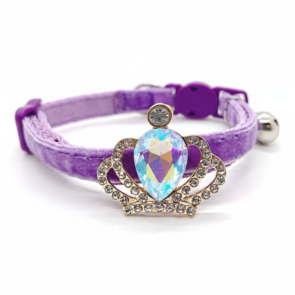 Purple velvet cat collar with gold crown pendant, large iridescent AB teardrop gem, rhinestone accents, safety breakaway buckle and silver bell — luxury cat collar
