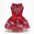 Red embroidered pet dress with matching satin bow on a white background