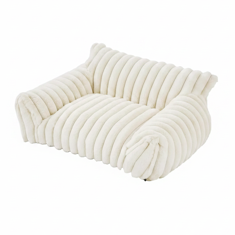 Cream white rectangular pet sofa bed with thick ribbed channel-tufted plush fabric, raised back and side bolsters, and a flat cushioned seat, shown at a 3/4 angle on a white background