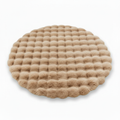 Round beige waffle-textured plush pet mat three-quarter view on white background