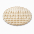 Round cream waffle-textured plush pet mat three-quarter view on white background