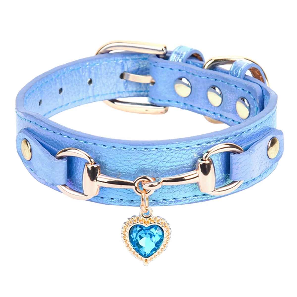 Metallic blue leather pet collar with gold snaffle-bit hardware, gold stud accents, and a blue crystal heart charm pendant, shown in close-up detail on a white background