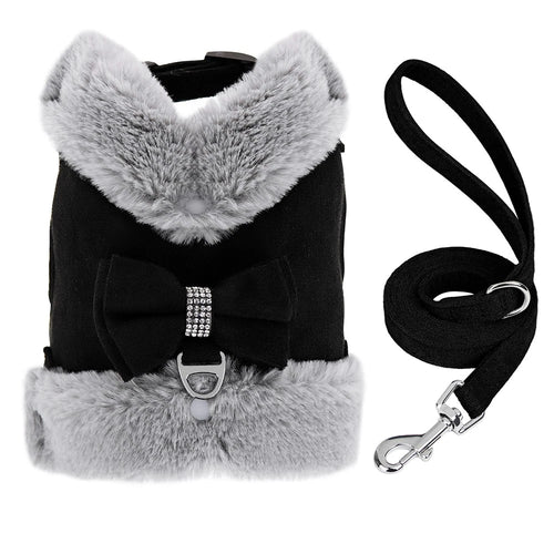 Black dog harness with light gray faux fur trim, a decorative bow with a rhinestone center, and a matching black leash with a silver clasp, shown on a white background.